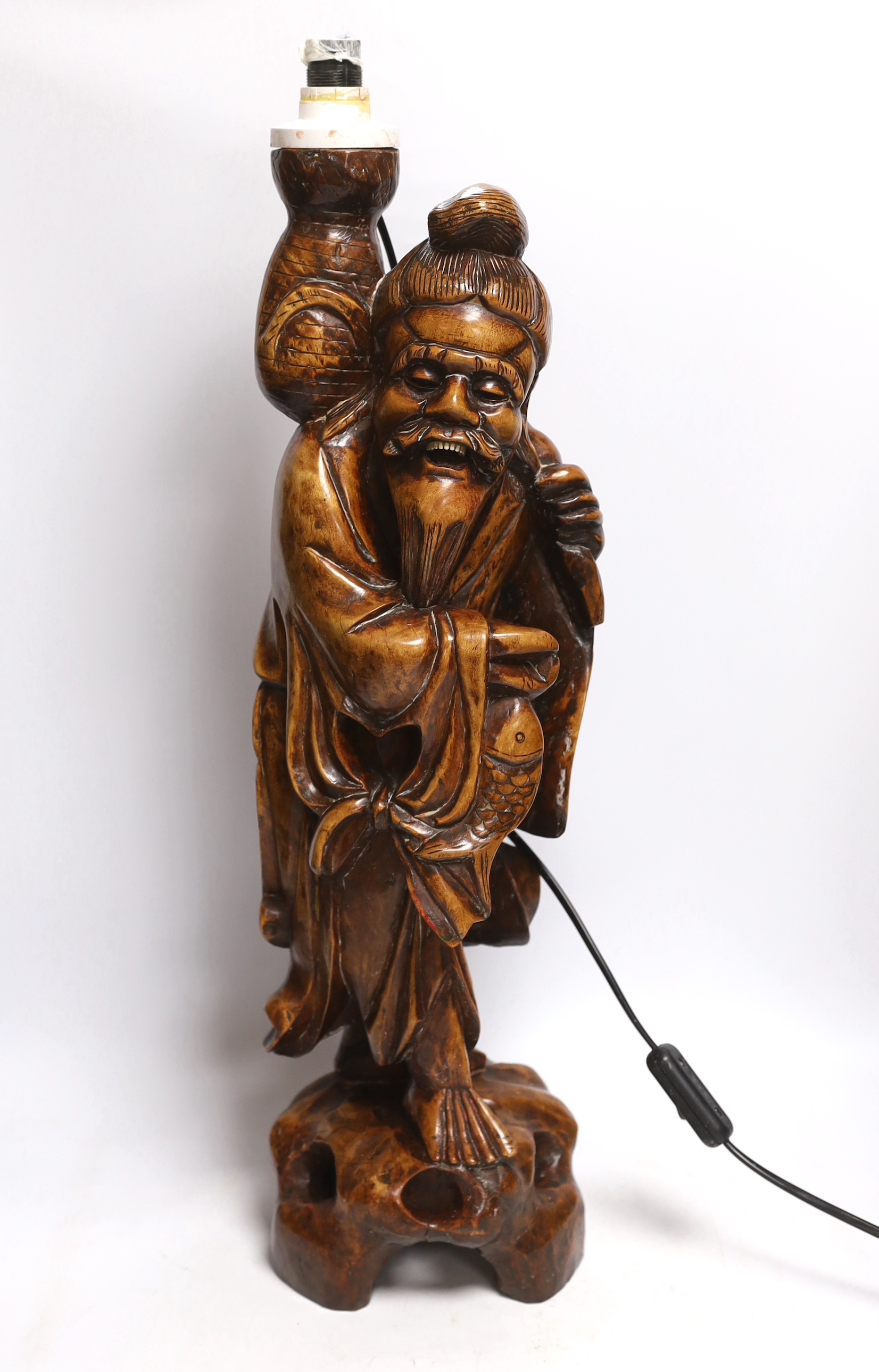 A Chinese carved wood figural lamp, 65cm high